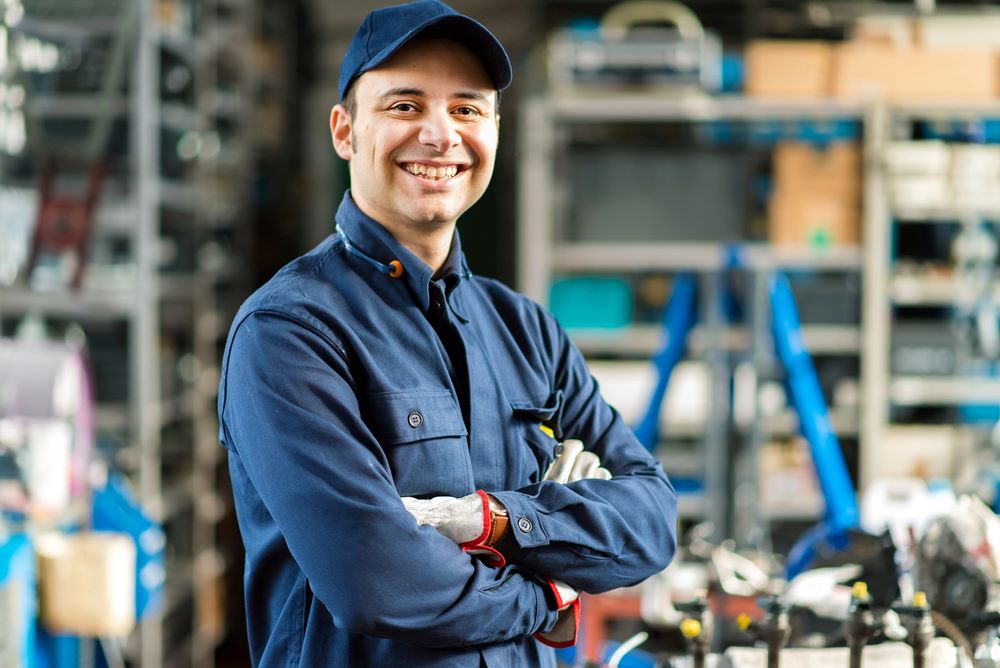 Image of a worker standing in front of his tools, featuring Hero Service Pros and highlighting 'Power Up Your Electrical Business' with professional support and solutions.